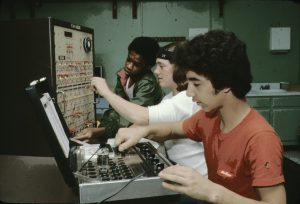 3 Students working on electronic devices