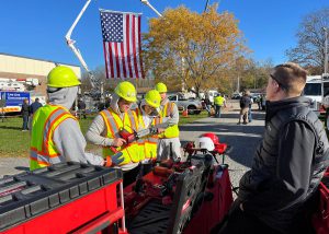 Group of students wearing safety gear and looking at tools