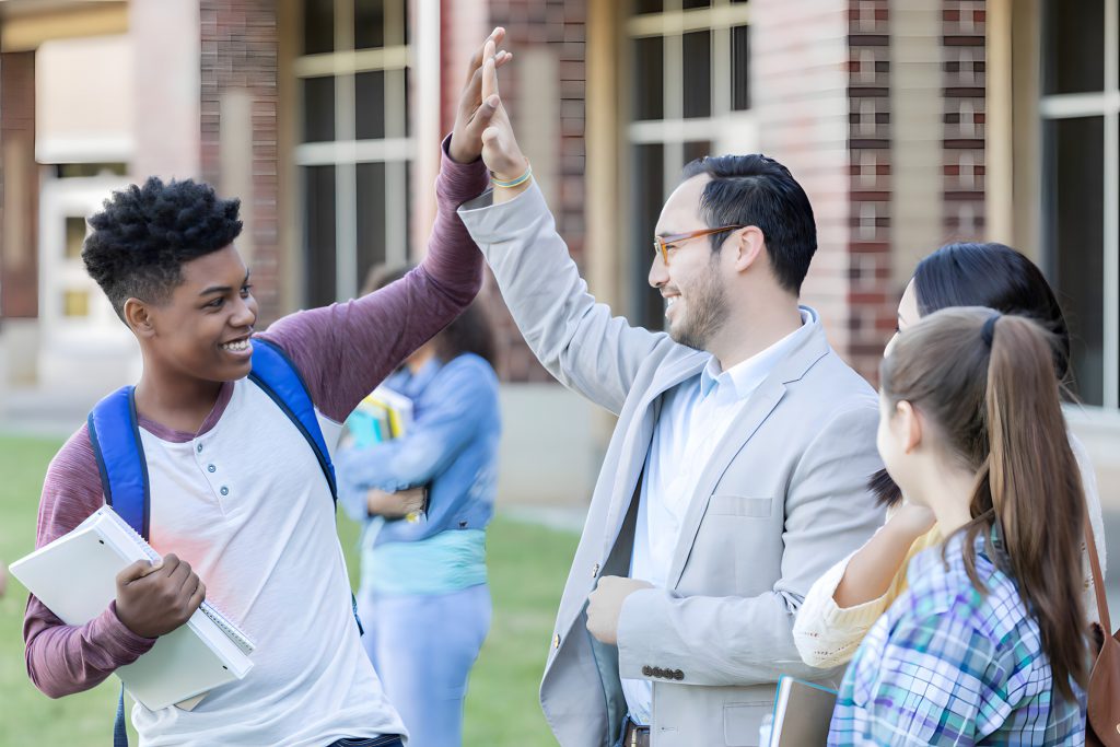 An adult and a young person exchange high fives