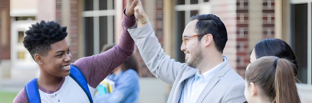 An adult and a young person exchange high fives