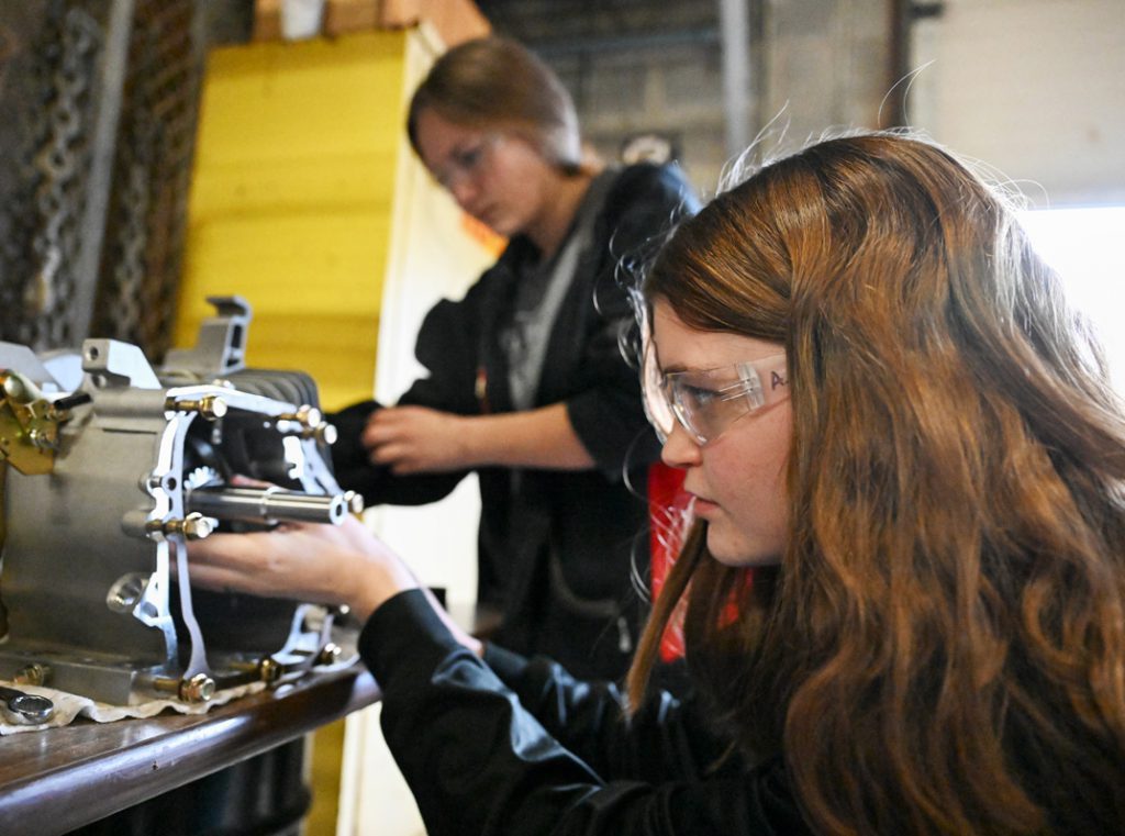 Female student works on project in machine shop