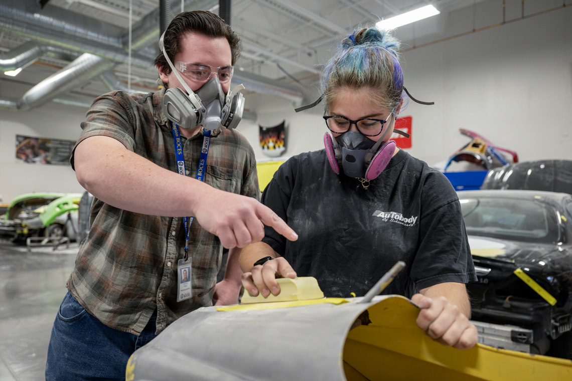 Capital Region BOCES Auto Body course instructor works with student.