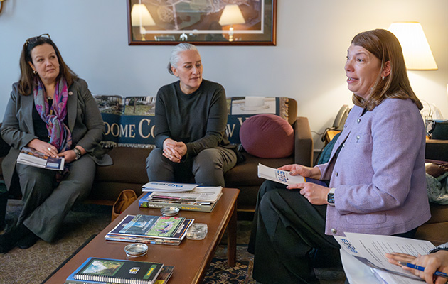 Three female administrators sit and talk