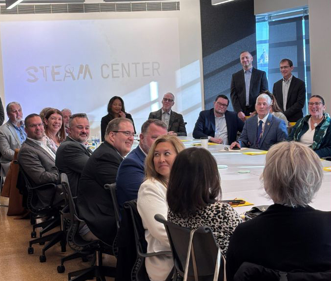 Several people seated around a conference room table.