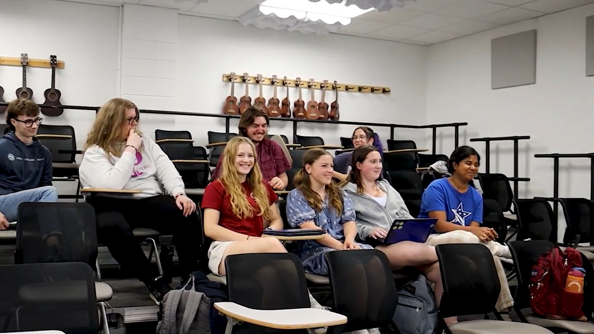 Schoharie CSD Youth Belonging Leadership Team club members sit in chairs during a meeting in a room at the school