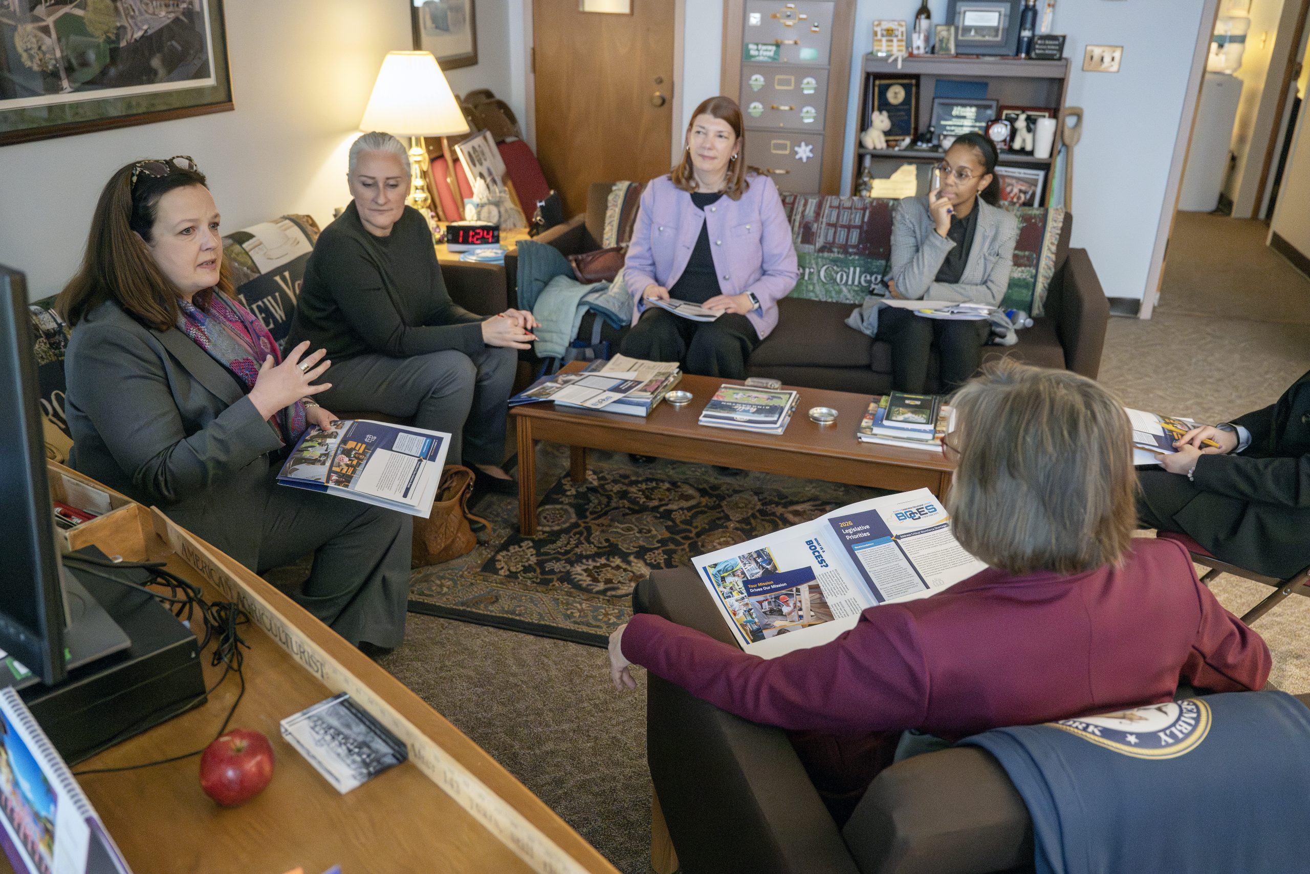 People sitting on couches and chairs talking to each other with BOCES of NYS printed materials in their hands and nearby during the BOCES of NYS Advocacy Day at the Legislative Office Buildings and Capitol in Albany on Wednesday, Feb. 25, 2026.